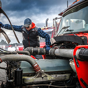 truck-mechanic-performs-engine-repair-during-cloud_300x300a